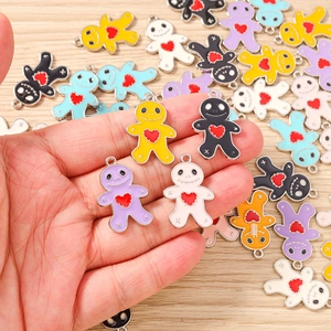 Detail view of colorful enamel voodoo doll charms with red hearts for DIY jewelry