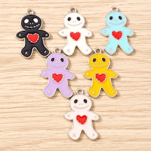 Macro view of six colorful gingerbread man skull charms with heart details for DIY jewelry
