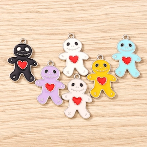 Detailed macro view of colorful gingerbread man enamel charms with red heart accents
