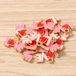 Close-up of heart-shaped LOVE letter charms for DIY necklaces and handmade jewelry