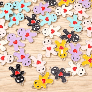 Macro view of colorful enamel doll pendants with red hearts for DIY jewelry making