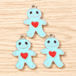 Close-up of blue cartoon character charms with red heart for DIY jewelry making