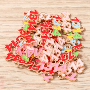 Macro detail of colorful 1314 enamel charms with gold plating for DIY jewelry making