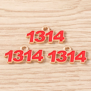 Close-up of red enamel 1314 number charms with gold alloy frames for DIY jewelry making