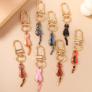 Cute 3D cat keychain collection with long swinging tails in multiple colors and golden plating