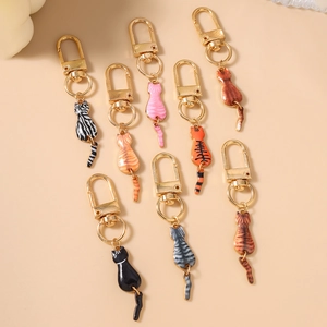 Set of eight colorful cartoon cat back charms with gold rotating metal keyrings