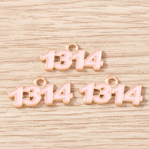 Detailed macro view of number 1314 light pink enamel charms with golden metal edges