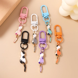 Set of six cute minimalist cartoon cat keychain pendants in assorted pastel enamel colors