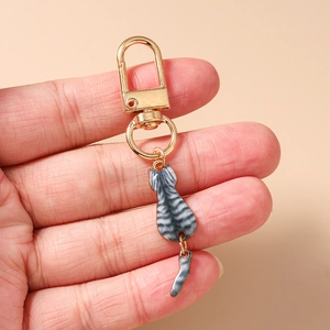 Detail of grey tabby cat keychain with lobster clasp and movable tail on gold metal ring