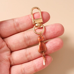 Close-up of a creative brown striped cat keychain with a gold D-ring metal clasp
