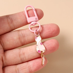Detailed view of a cute cartoon cat keychain with pink lobster clasp and enamel pendant