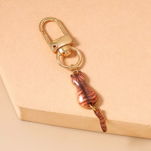 Detailed view of a cute brown tabby cat keychain with a movable tail and golden clasp