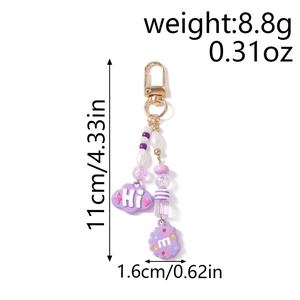 Detail showing a purple beaded keychain with dimensions 11cm by 1.6cm and metal clasp