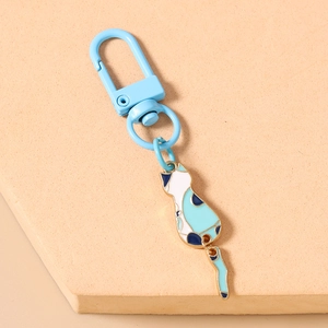 Close-up of cute cartoon cat keychain with light blue D-ring and enamel pendant charm