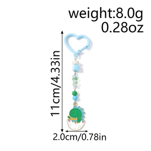 Détail porte-clés dinosaure avec perles, dimensions 11cm et fermoir en cœur bleu