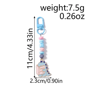 Close-up of cute blue dinosaur charm keychain with colorful beads and lobster clasp