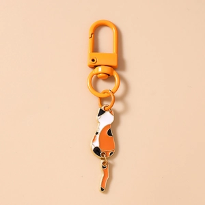 Detailed macro view of calico cat keychain with orange lobster clasp and movable tail