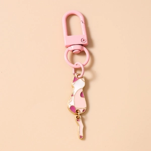 Detail of pink metal carabiner and cute white enamel cat pendant with a swinging tail