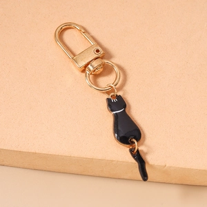 Detail of a cute black cat keychain with gold-plated alloy and lobster clasp accessory