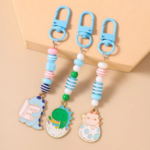 Cute cartoon dinosaur keychain set with colorful beads and sweet enamel pendants