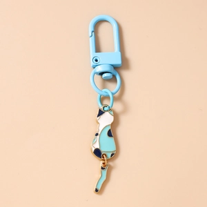 Detailed close-up of blue enamel cat keychain with rotating tail and D-ring buckle