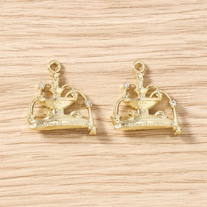 Detailed close-up of gold enamel fountain pendants with star engravings and zircons