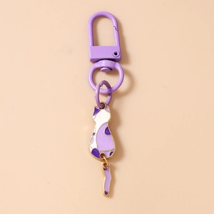 Macro detail of purple and white cartoon cat keychain with rotating D-ring clasp
