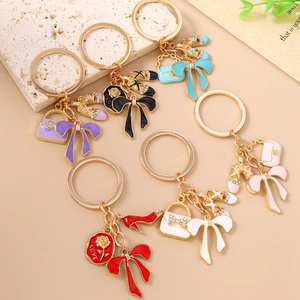 Elegant rhinestone keychain with enamel rose, bow, and shoe charms for handbag decoration