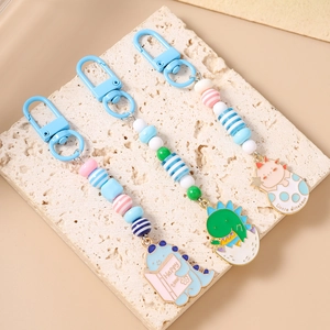 Three cute beaded dinosaur keychains with colorful acrylic beads and metal carabiner clips