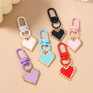 Set of six colorful mosaic pixel heart keychains with golden metal trim and spring hooks
