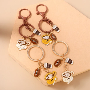 Set of 4 coffee-themed keychains with cup and bean charms in gold and brown finish