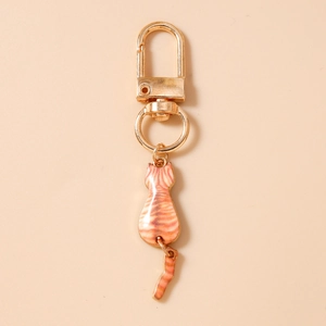 Detail of cute orange cat keychain showing the gold alloy finish and moving tail charm