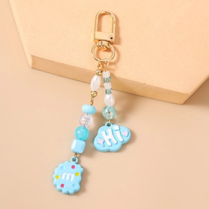 Detailed close-up of a blue cloud pendant and beaded keychain with lobster clasp