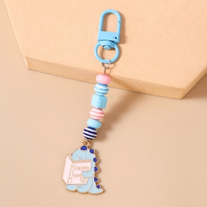 Detail of beaded keychain with cute cartoon dinosaur pendant and happy time text