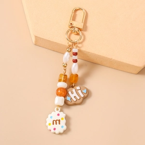 Detailed beaded keychain featuring resin cloud and cookie charms with golden D-ring clasp