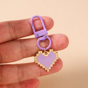 Detailed view of a purple mosaic heart keychain with pixelated edges and matching lobster clasp