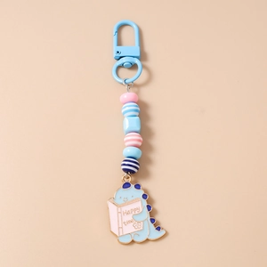 Detail of cute blue enamel dinosaur keychain with colorful acrylic beads and carabiner