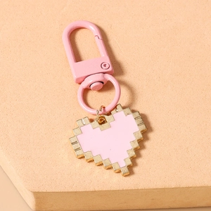 Close-up of pink mosaic pixel heart keychain with gold-plated spring clasp and ring