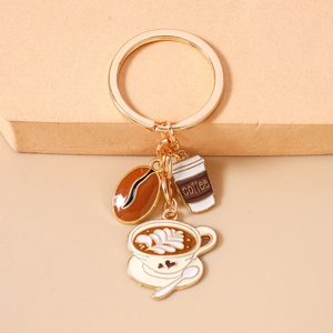 Detailed coffee bean and latte art charms on golden metal keychain for handbag