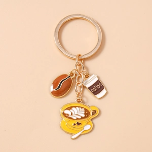 Detail of creative coffee-themed gold keychain with coffee bean and mini cup charms