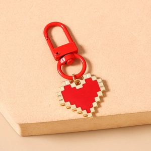 Detailed view of red mosaic pixel heart keychain with gold edges and matching D-ring