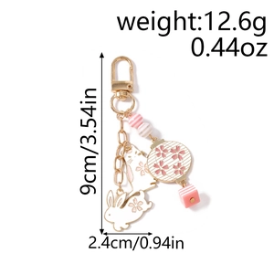 Detailed view of pink cherry blossom rabbit keychain with dimensions 9cm and weight 12.6g