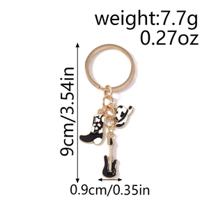 Detail of keychain featuring cowboy hat, boot, and guitar charms with size dimensions