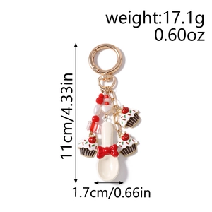 Detail view of cupcake keychain with spoon and red cherry charms including measurements