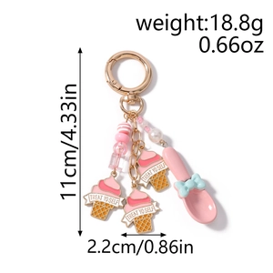 Detail of Treat Yo Self ice cream keychain with pink spoon and beaded charm accents