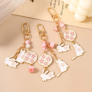 Pink and white cat and rabbit beaded keychains with lanterns and cherry blossoms