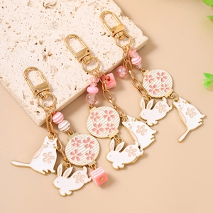 Charming cherry blossom cat and rabbit beaded keychains with pink enamel pendants