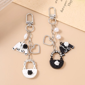 Elegant beaded heart keychain with classic tweed jacket and camellia charms for handbags