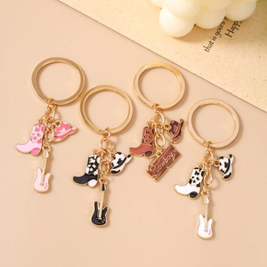 Set of four western cowboy style keychains with cow print boots and electric guitars
