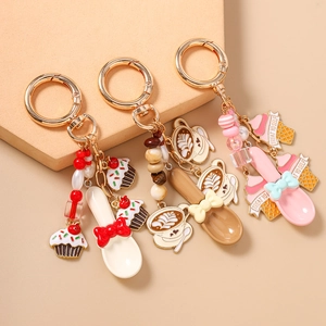 Three dessert-themed keychains with cupcake, coffee latte and ice cream pendants in warm tones